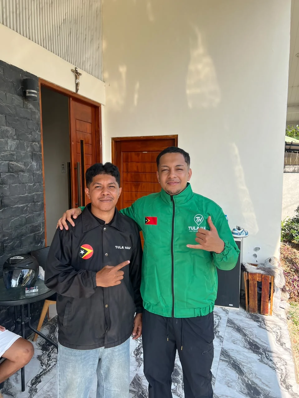Two TULA-HAU team members at the entrance of a building