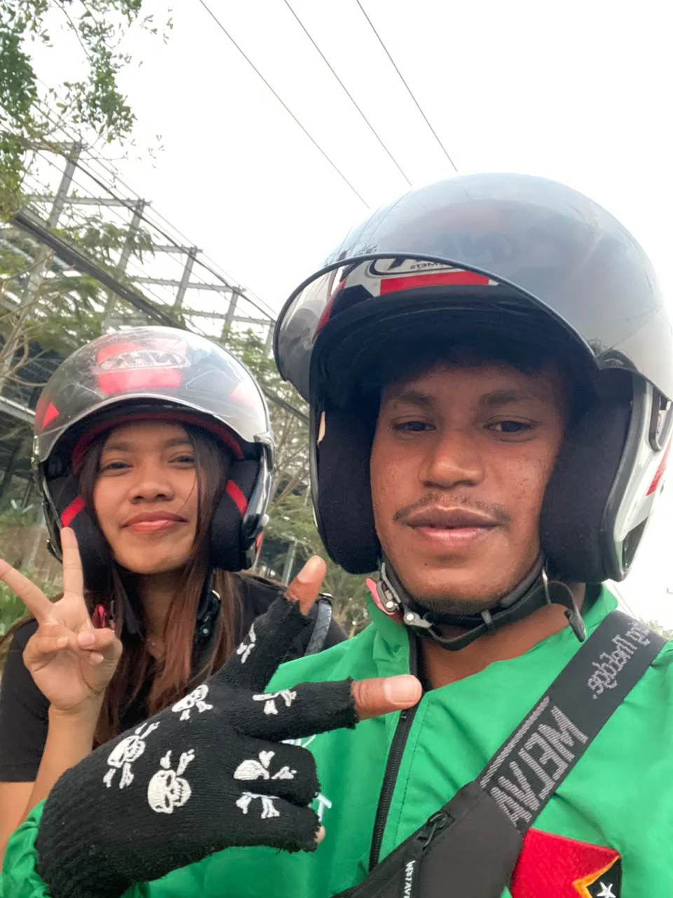 A TULA-HAU driver and a passenger in helmets taking a selfie